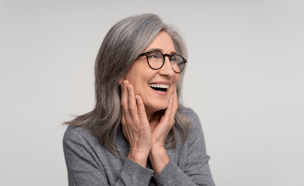 An Elderly Lady Smiling After A Dental Bridge