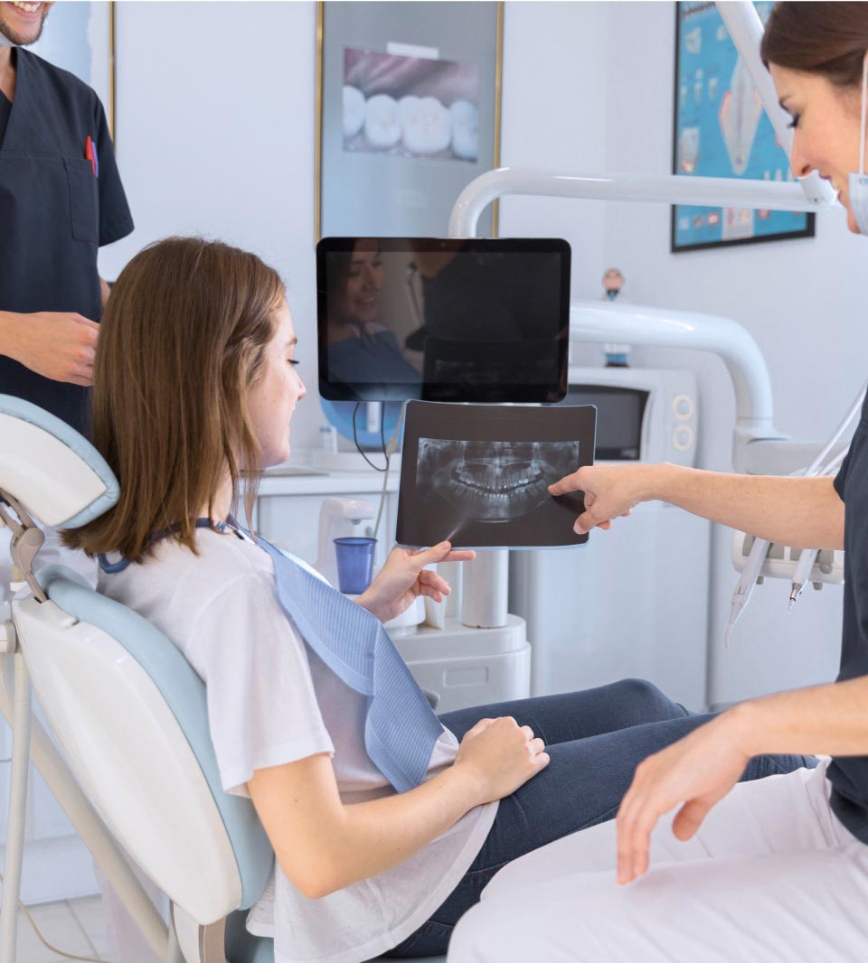 Dentist Showing Dental X-ray To The Patient