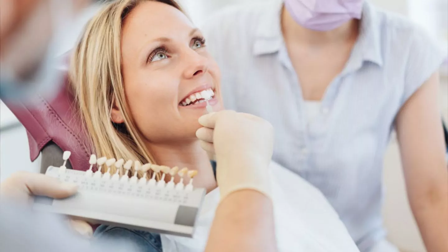 Dentist Matching Veneers Shade With Patient Teeth